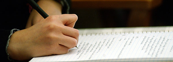 Photo of Notebook with Student Taking Notes